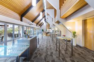a lobby of a restaurant with tables and windows at Crowne Plaza Queenstown by IHG in Queenstown
