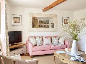 a living room with a pink couch and a table at 3 Bed in Niton oc-73299 in Niton