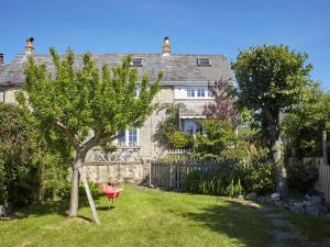 a house with a red chair in front of a yard at 3 Bed in Niton oc-73299 in Niton