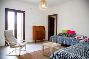 a living room with two beds and a chair at Villa Santa Lucia in Noto +71 photos