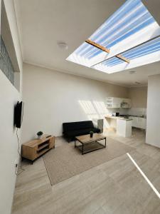 a living room with a couch and a skylight at Gottys Lagoon Stay in Walvis Bay