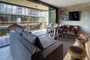 a living room with a couch and a table at Ideal Location with Cenote Pools Gym Restaurant in Tulum