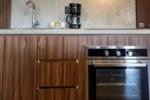 a kitchen with a stainless steel oven and a sink at Ideal Location with Cenote Pools Gym Restaurant in Tulum