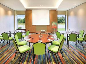 a conference room with tables and green chairs at Ibis Styles Bogor Raya in Bogor +38 photos