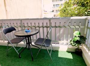 a small table and two chairs on a balcony at Karma Seaside Apartment in Perea +2 photos