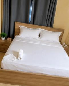 a bed with a roll of toilet paper sitting on it at Lilia Business Hotel in Ouagadougou