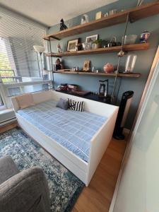 a bedroom with a bed with a blue mattress at Vancouver Condo-Park-Walk to Stadium-Sleeps 4 in Vancouver