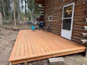 a wooden deck on the side of a log cabin at Little Dry Cabin #3 in Fairbanks