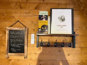 a wall with a shelf with books and a sign at Little Dry Cabin #3 in Fairbanks +44 photos