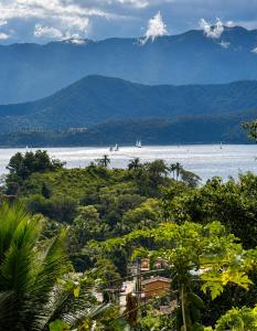 a view of a body of water with mountains at Studio Shogun Vista, Ar, Vaga 5 min do mar in Ilhabela