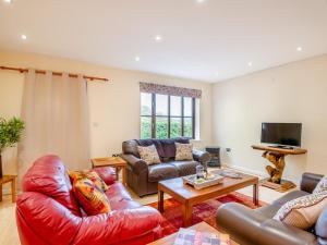 a living room with leather furniture and a tv at 2 Bed in Monmouth oc-93650 in Trelleck