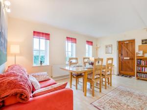 a living room with a red couch and a table at 2 Bed in Monmouth oc-93650 in Trelleck