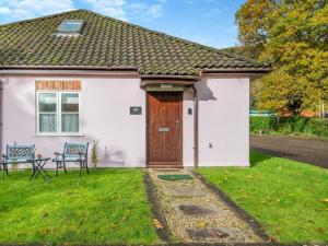a small white house with a wooden door at 2 Bed in Monmouth oc-93650 in Trelleck