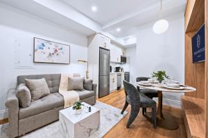 a living room with a couch and a table at Casa Hotels Gerrard Private Basement Suite in Toronto