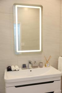 a bathroom with a white sink and a mirror at 232D South Finger in Jolly Harbour +14 photos