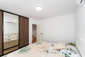 a bedroom with a bed and a large mirror at Sky Lounge & More - Rooftop Wellness & Gym in Zadar