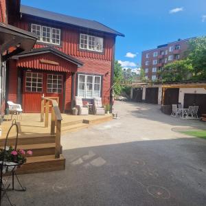 a house with a deck and a building at Central City Apartment B in Nyköping