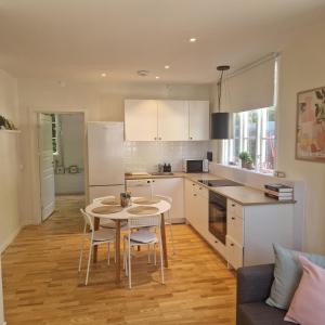 a kitchen with a table and chairs in a room at Central City Apartment B in Nyköping