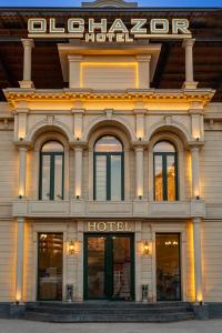 a hotel building with a sign on top of it at Olchazor hotel in Tashkent