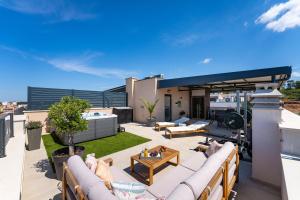 an outdoor patio with furniture on a roof at Sky Lounge & More - Rooftop Wellness & Gym in Zadar