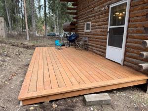 a wooden deck on the side of a cabin at Little Dry Cabin #3 in Fairbanks