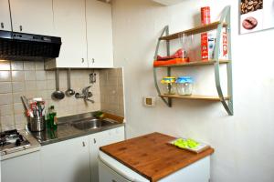 a kitchen with a sink and a wooden table at Alla Cattedrale - Locazione Turistica in Sulmona
