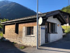 a small building with a sign in front of it at Chalet Alpen Charme in Turtmann