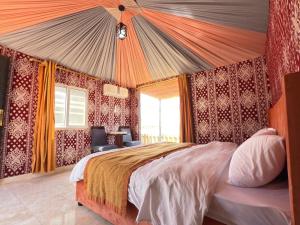 a bedroom with a large bed in a room at Al Raha Luxury Camp in Wadi Rum