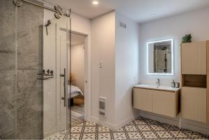 a bathroom with a shower and a sink at Käbane Nova - La Chaleureuse in Baie-Saint-Paul +18 photos