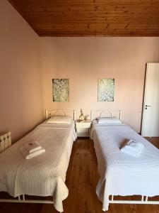 a room with two beds and a sink in it at S&E home in Nikiana