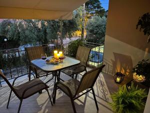 a table with candles and chairs on a patio at S&E home in Nikiana
