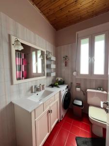 a bathroom with a sink and a toilet at S&E home in Nikiana +5 photos