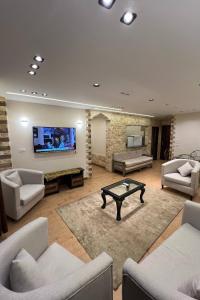 a large living room with couches and a table at Pyramids Gardens Hotel in Cairo