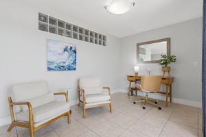 a living room with two chairs and a table at Stunning Sunset Scenes in Wesley Chapel