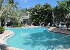 a large pool with blue water in a resort at Charming Key West Rental in Key West