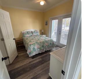a bedroom with a bed and a window at Charming Key West Rental in Key West