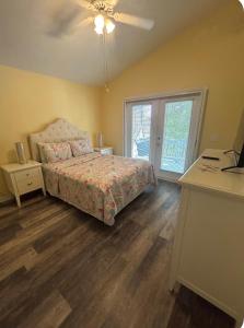 a bedroom with a bed and a desk and a window at Charming Key West Rental in Key West +3 photos