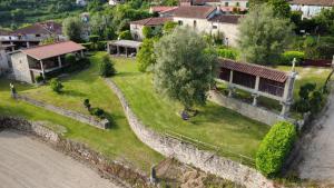 an aerial view of a house next to a river at Quinta do Paço - Casa do Caseiro in Vila Verde