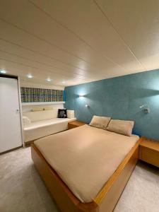 a bedroom with a large bed and a bath tub at Yacht Laetitia Delta in Fréjus