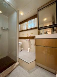 a bathroom with a shower and a toilet at Yacht Laetitia Delta in Fréjus