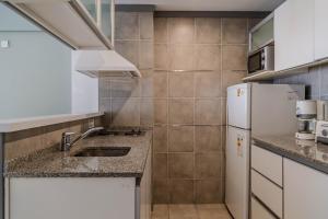 a kitchen with a sink and a refrigerator at Color Botánico in Buenos Aires +289 photos