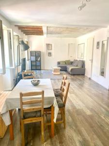 a living room with a table and chairs and a couch at Casa Alice in Muggia