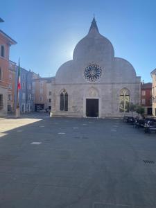 a large building in a parking lot in a city at Casa Alice in Muggia +2 photos