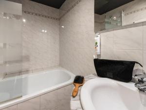 a bathroom with a sink and a bath tub at ibis Styles Moulins Centre in Moulins