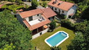 an aerial view of a house with a swimming pool at Sobreiros House - Gerês in Terras de Bouro