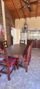 a wooden table and chairs in a kitchen at Cabañas del bosque in Merlo