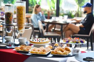 a table topped with different types of pastries and cakes at Hotel HW Libertad in Santiago