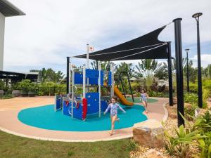 two children playing on an outdoor playground at Mercure Darwin Airport Resort in Darwin