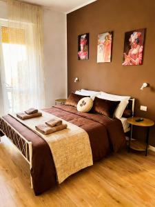 a bedroom with a large bed with towels on it at Sea Breeze Suites in Livorno