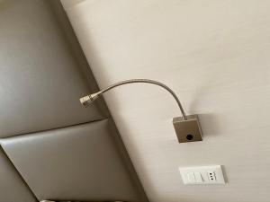 a light on the corner of a wall with a lightswitch at AMLÈ in Papozze